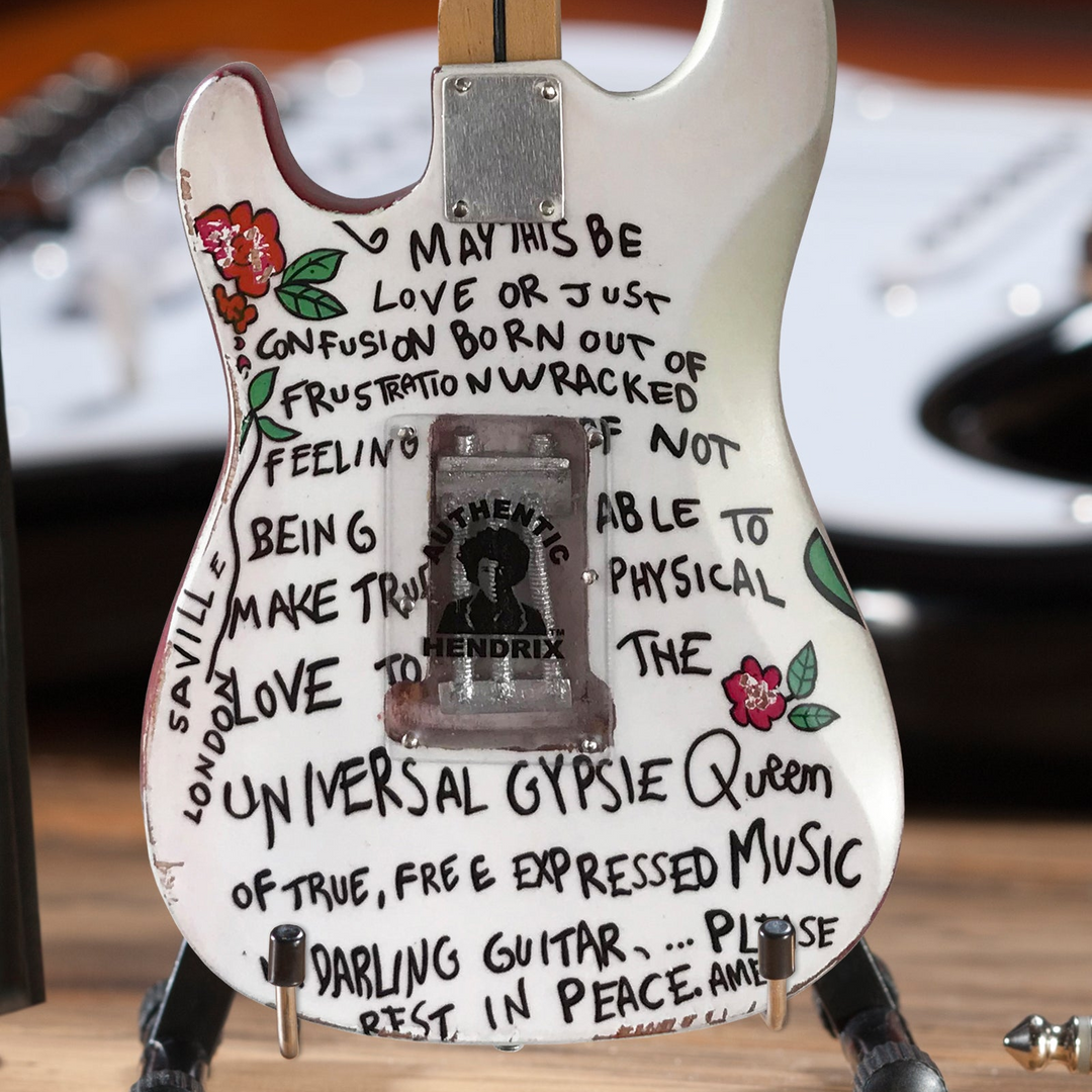 Jimi Hendrix Fender Stratocaster Mini Guitar Replica with hand-painted lyrics and floral design, front view.