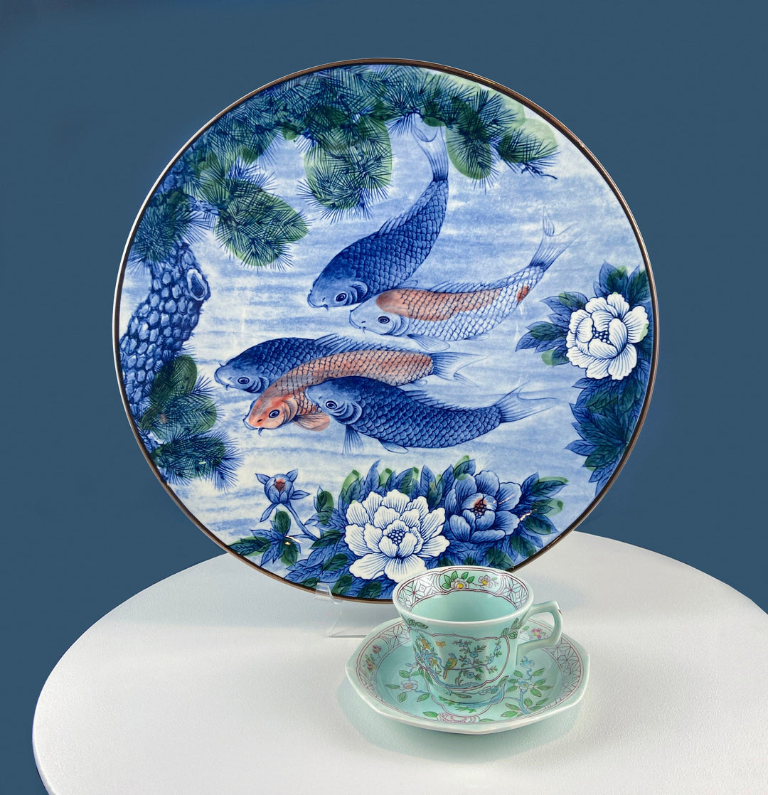 Handpainted Koi Fish Platter: Japanese Collectible Art Plate, 16" on display with delicate tea cup.