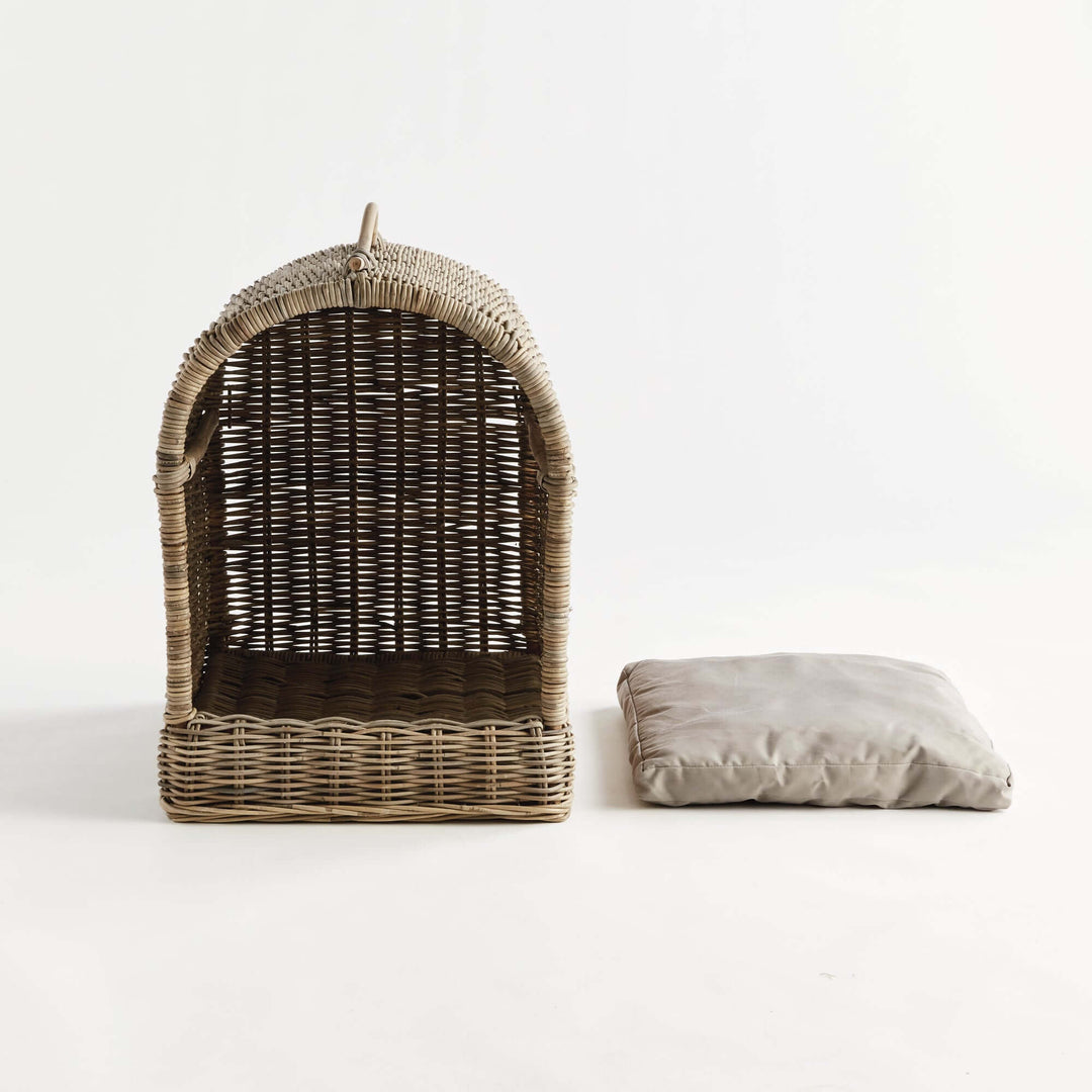 Handwoven rattan canopy dog bed with detachable cushion, providing stylish comfort for pets.