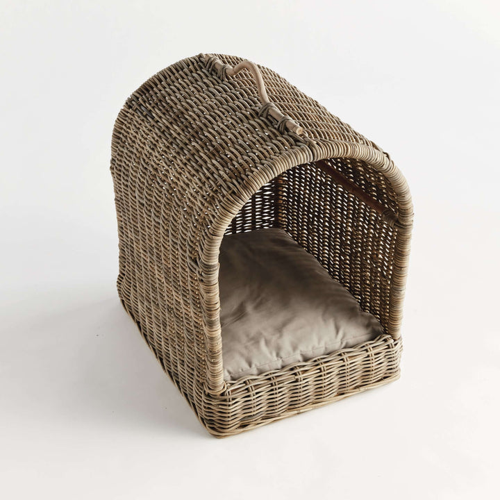 Handwoven rattan canopy dog bed with cushion, providing a cozy retreat for pets.