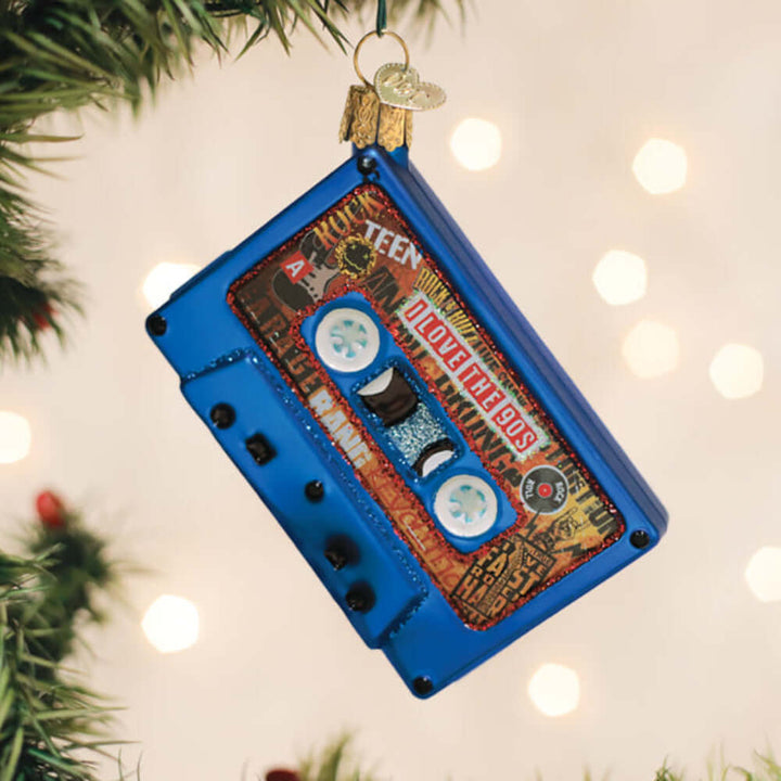 I Love the 90s Cassette Tape Christmas Ornament hanging on a Christmas tree, capturing mixtape nostalgia with retro design elements.