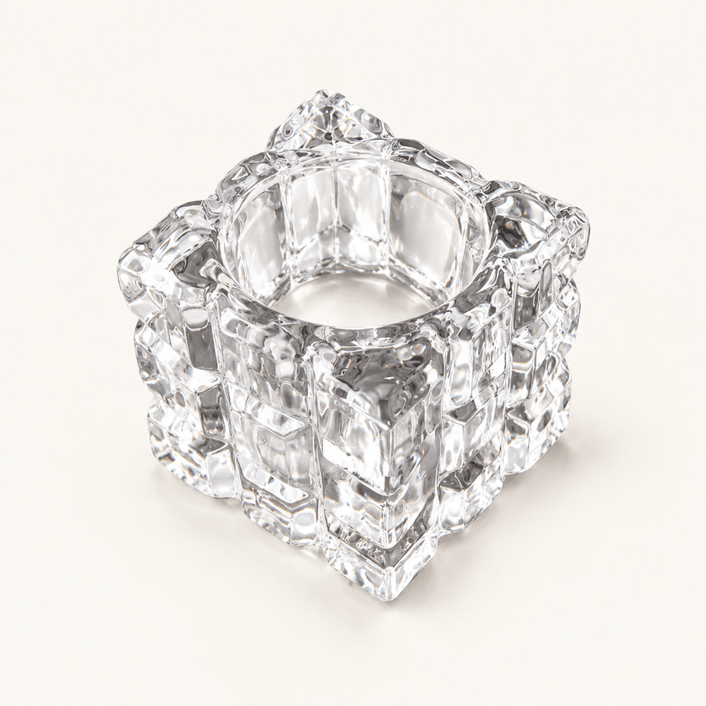 Empty clear glass cube tealight holder with an ice-like textured surface on ivory.