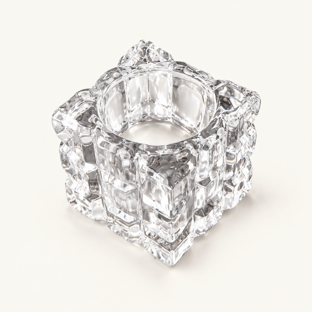Empty clear glass cube tealight holder with an ice-like textured surface on ivory.