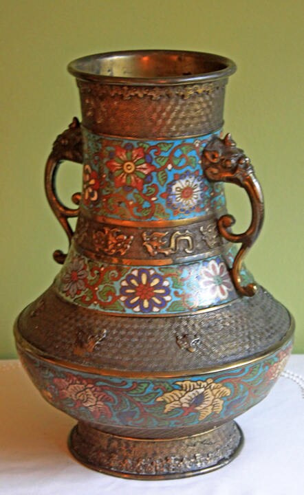 Vintage hand-painted metal vase with intricate floral designs and dragon handles, showcasing exquisite craftsmanship.