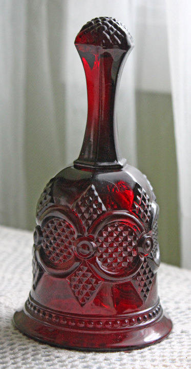 Glass Bell by Avon - Cape Cod Collection Ruby Color Sandwich Glass with embossed design and translucent red color.