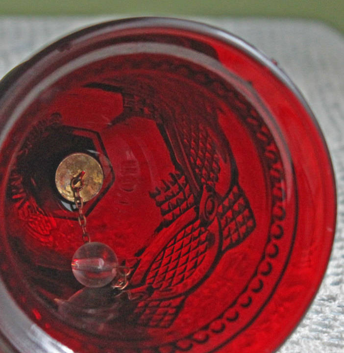Glass Bell by Avon - Cape Cod Collection Ruby Color Sandwich Glass interior view showcasing embossed design and vibrant red color.