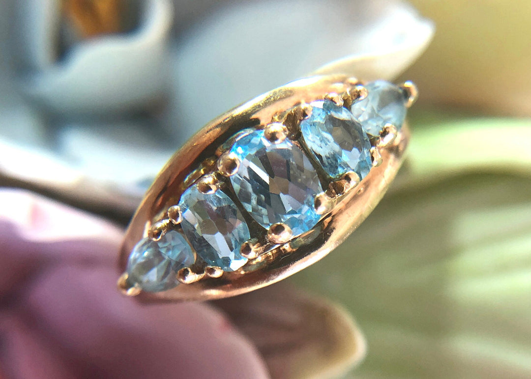 Vintage 10k Gold Ring with 5 Blue Topaz Stones showcasing beautiful oval blue topaz gems.