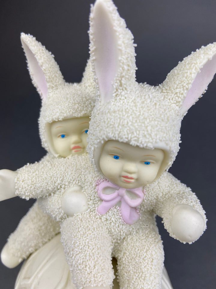 Collectible Snowbabies figurine with two bunnies, featuring soft detailing and playful expressions. Perfect holiday decor.