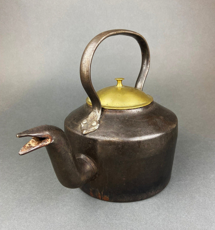 Antique Iron Kettle with Brass Lid - J&J Siddons - Westbromwich displayed at an angle, showcasing its spout and handle.