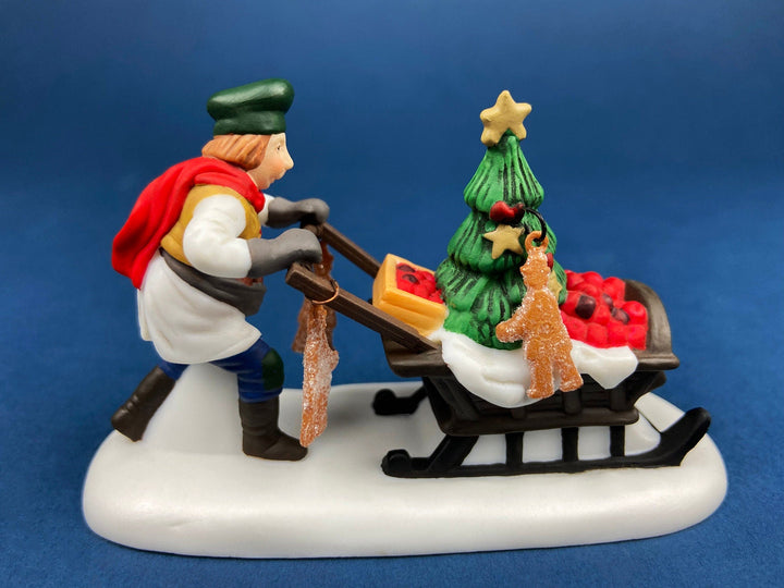 Department 56 Dickens Village Gingerbread Vendor with Kids figurine featuring a vendor and children with Christmas tree.