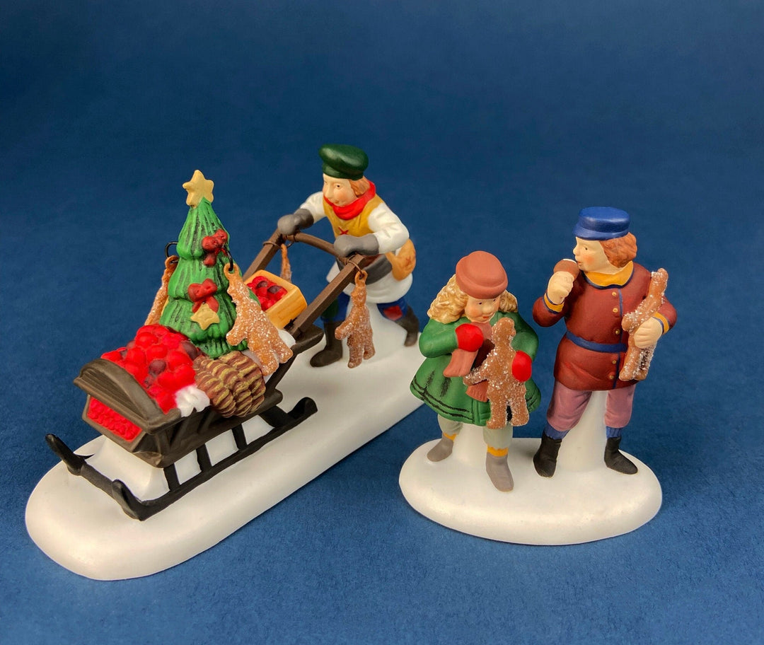 Department 56 Dickens Village Gingerbread Vendor with Kids figurines in Christmas scene.