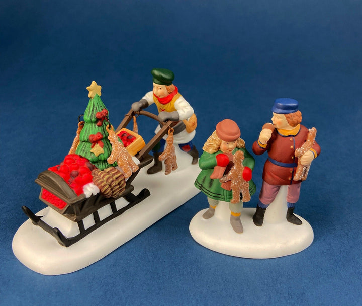 Department 56 Dickens Village Gingerbread Vendor with Kids figurines in Christmas scene.