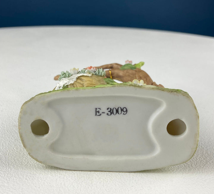 Bottom view of Porcelain Figurine by Marks & Rosenfeld of Little Girl Planting Flowers with E-3009 marking.