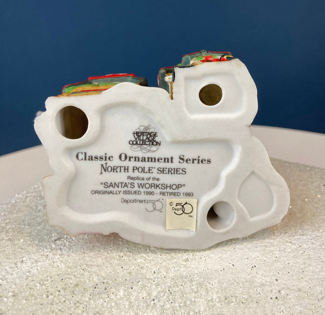 Set of 3 Tree Ornaments by Dept 56. Porcelain Hand Painted Bldgs.: Dedlock Arms, Santa's Workshop, and Dickens'Village Mill.
