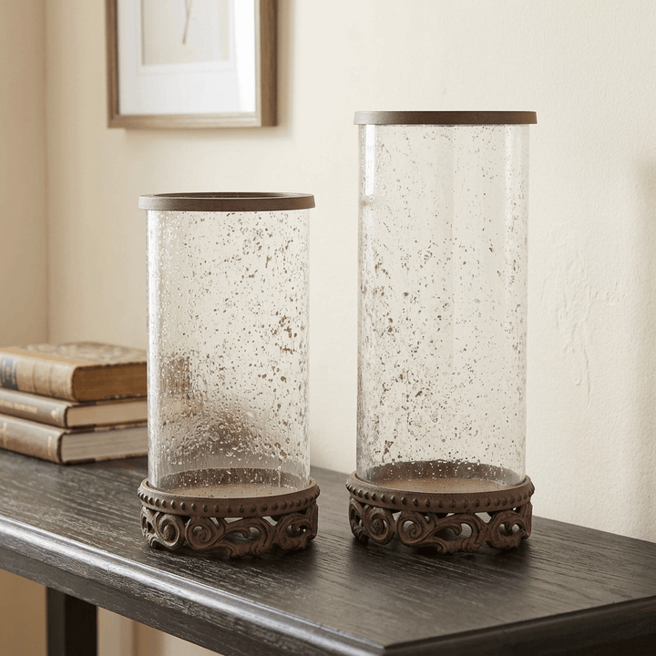 Both sizes of Bellavita Glass Hurricane Candle Holder styled together on a wooden console; each size sold separately.