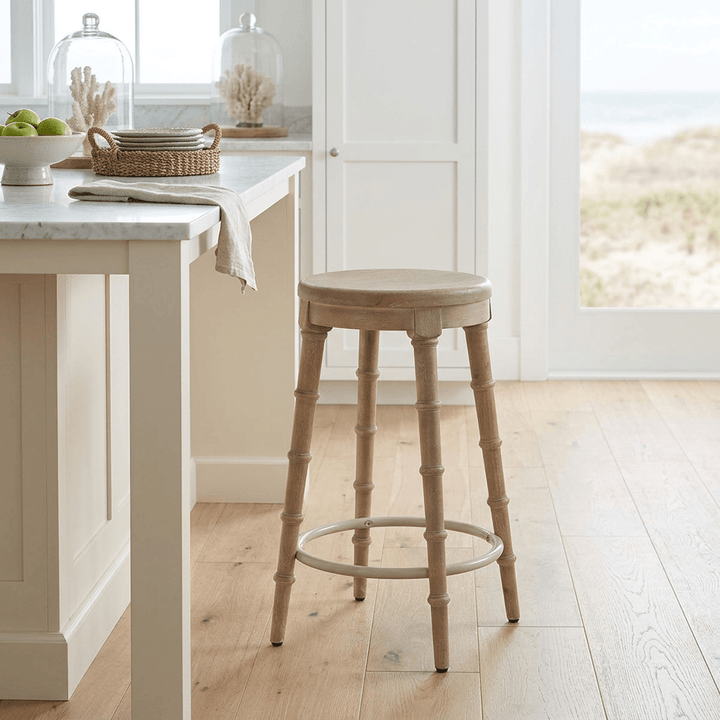 Spindrift Counter Stool in the Driftwood finish beside a kitchen island in a bright coastal kitchen