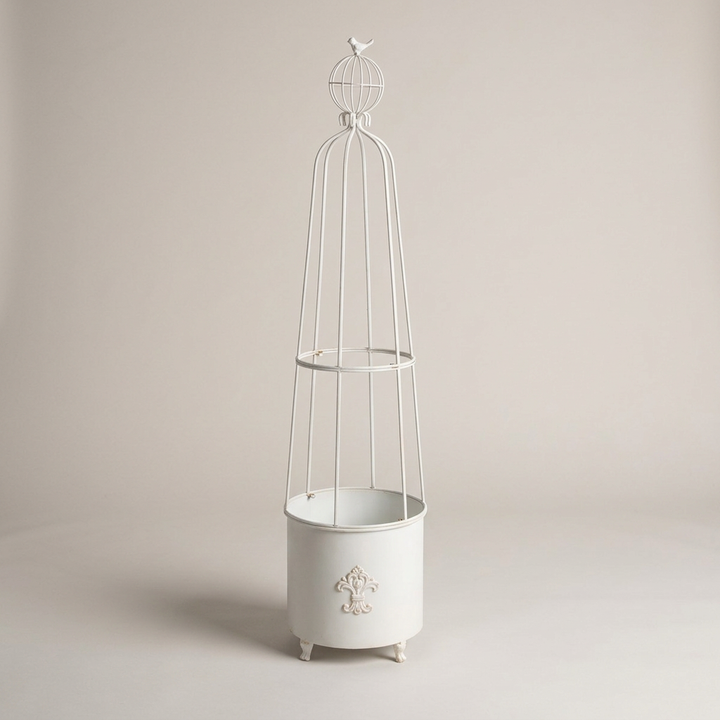 Antiqued White Fleur-de-Lis Garden Planter Obelisk on a warm gray studio background