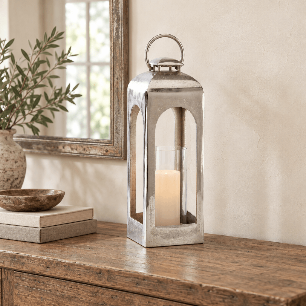 Silver arched lantern styled with an ivory flameless candle on an oak entry console