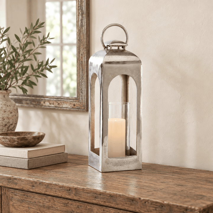 Silver arched lantern styled with an ivory flameless candle on an oak entry console