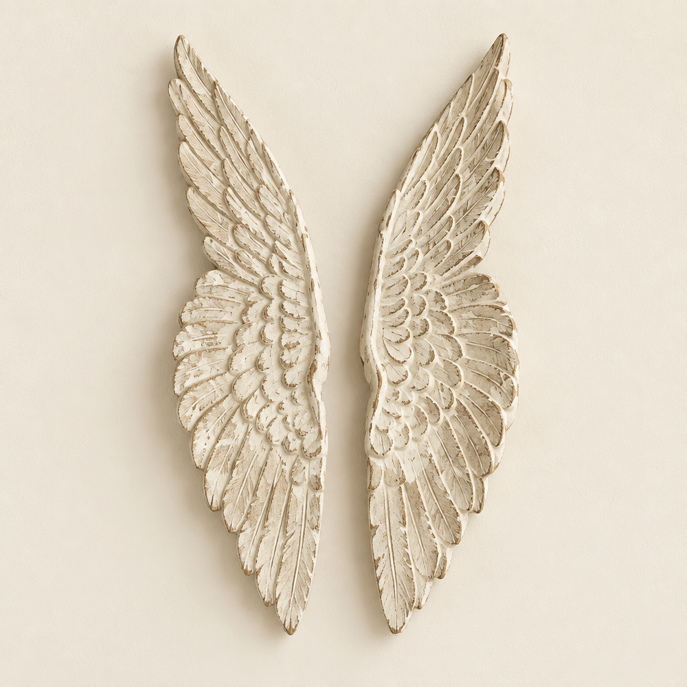Pair of distressed wooden angel wings against an ivory wall