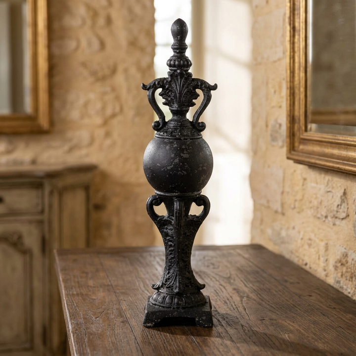 Black Manor Decorative Finial with ornate scrollwork on a wooden console