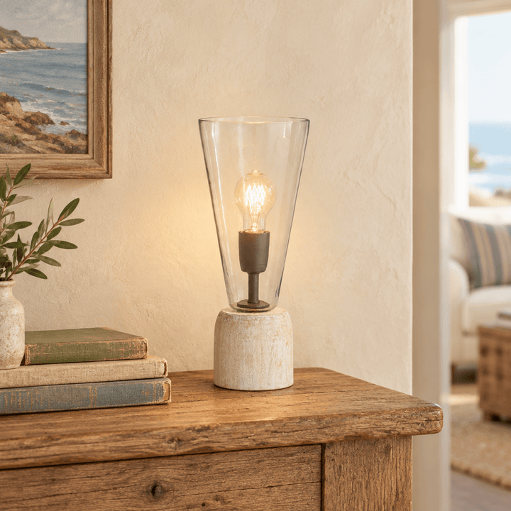Whitewashed wood and clear glass mini lamp styled beside vintage books on an oak console