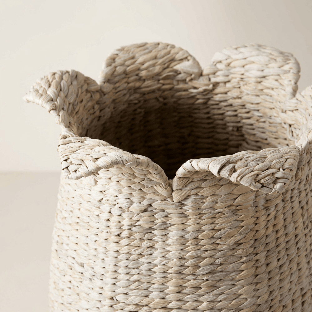 Close-up of a Petalweave basket's folded petal-shaped rim and whitewashed water hyacinth weave.