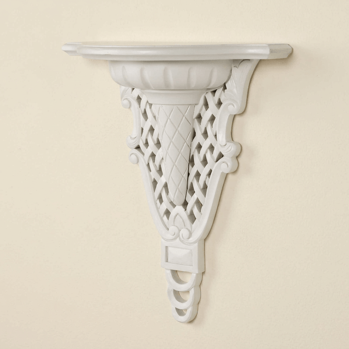 White Avelisse Wall Ledge with carved latticework and scrolling support against an ivory wall.