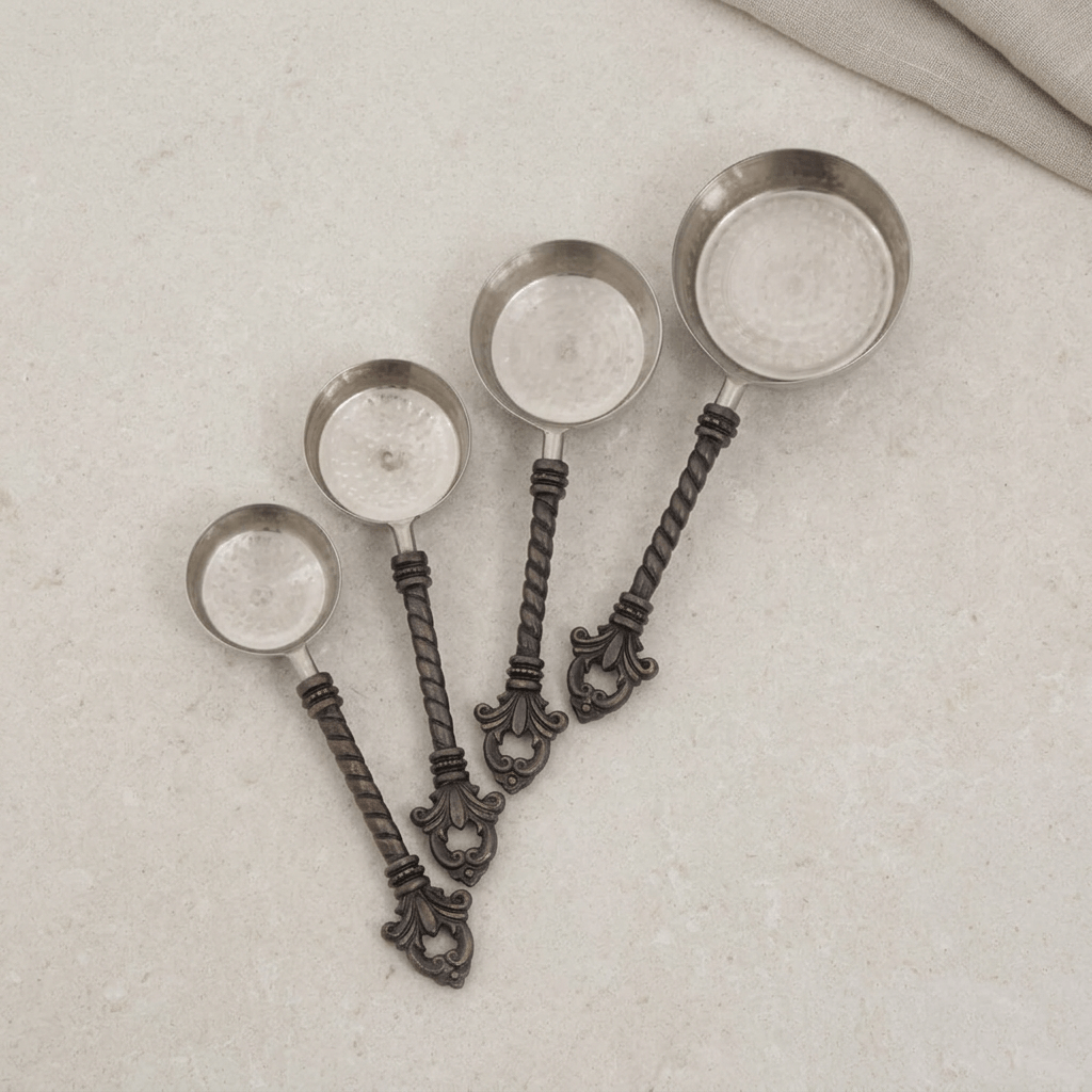 Top-down view of four Bellavita measuring cups on pale stone, matching the original product view