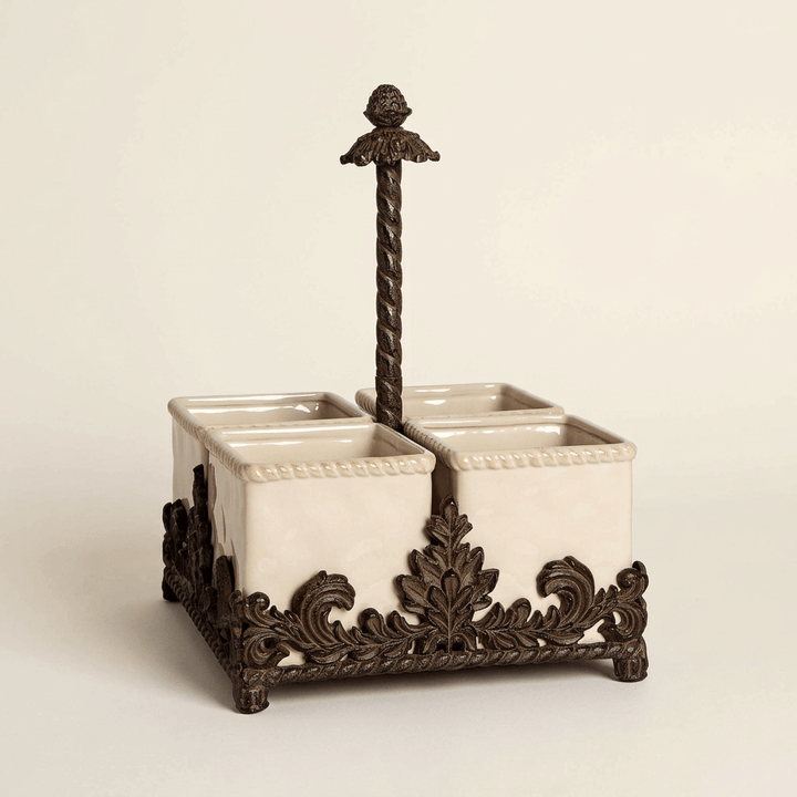 Bellavita flatware caddy with four cream stoneware containers in an ornate dark brown metal base on a neutral backdrop