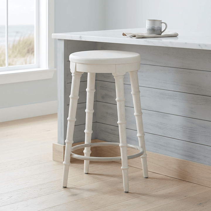 Spindrift Counter Stool in the Whitewash finish beside a kitchen island in a bright coastal kitchen