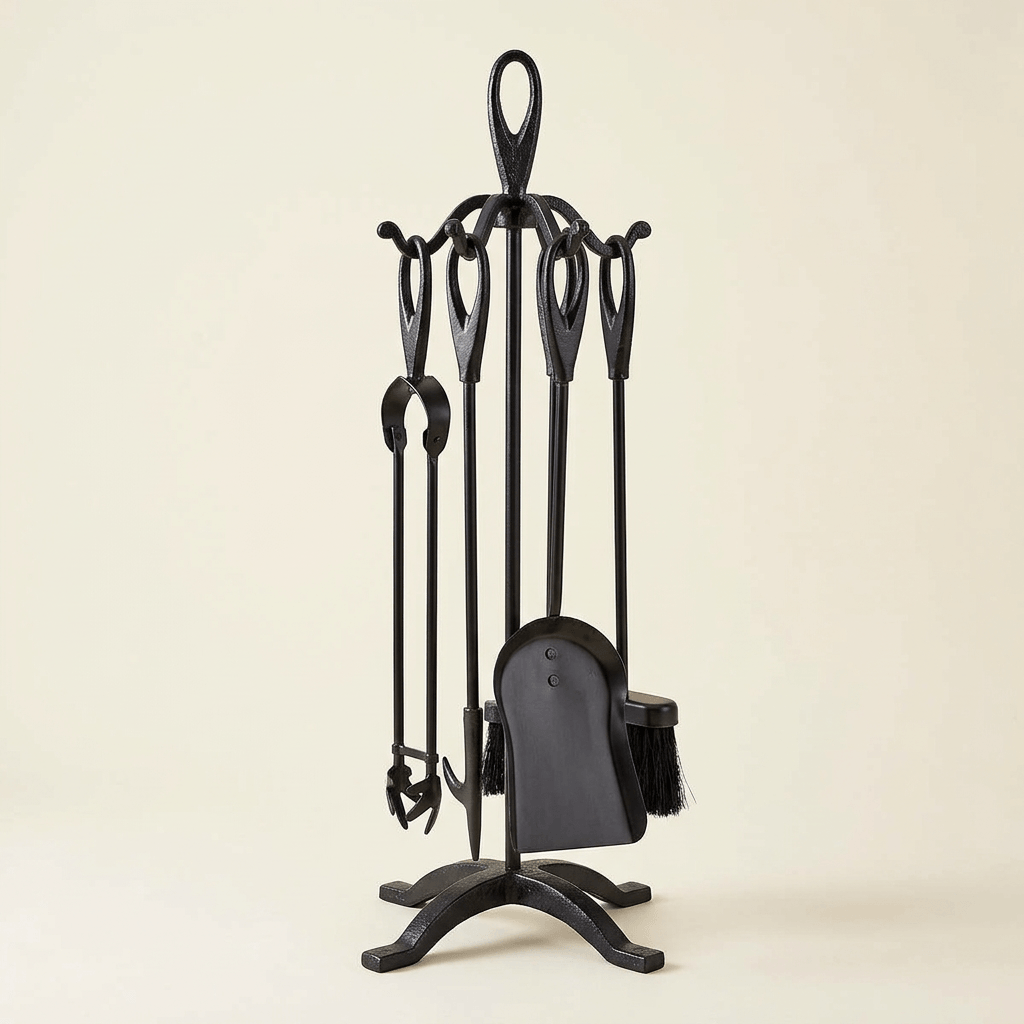 Black wrought iron fireplace tool set with four hanging tools and a freestanding stand on an ivory background
