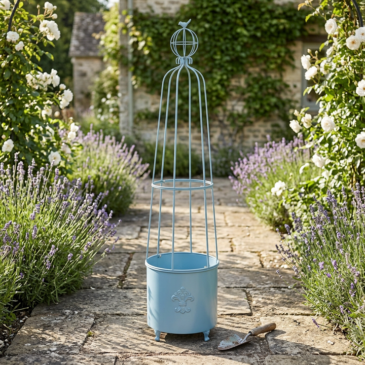 Provence Blue Fleur-de-Lis Garden Planter Obelisk in a cottage garden