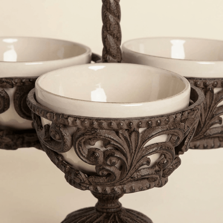 Close-up of cream ceramic bowl, beaded rim and scrolling acanthus metalwork on Bellavita Stoneware Condiment Server.