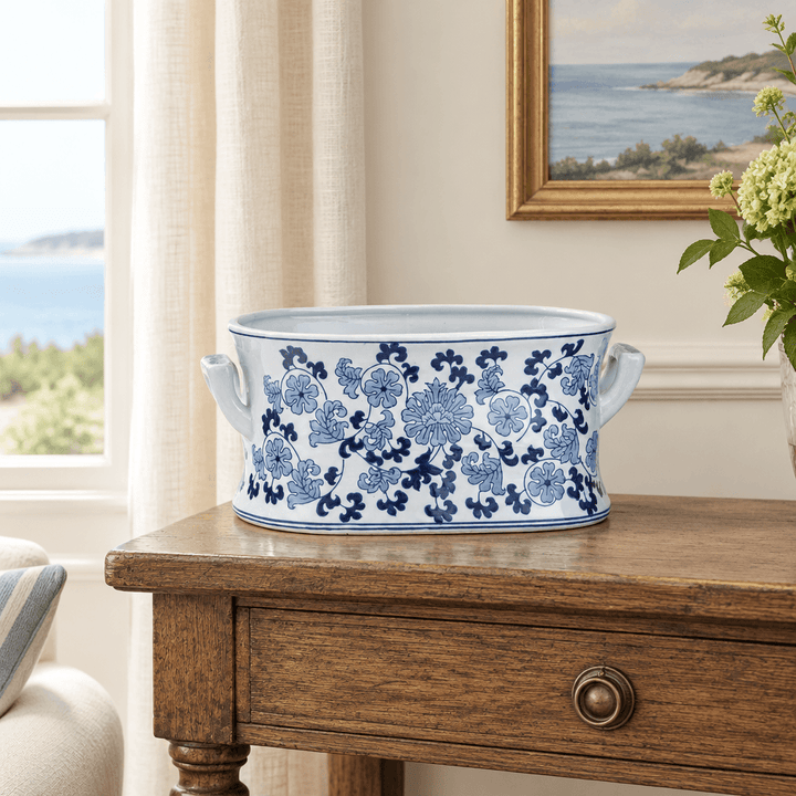 Blue and white porcelain lotus planter styled on an oak console in a coastal-inspired room