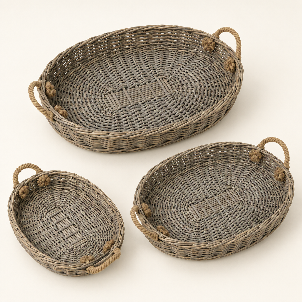 Three graduated oval willow trays with jute handles on an ivory background