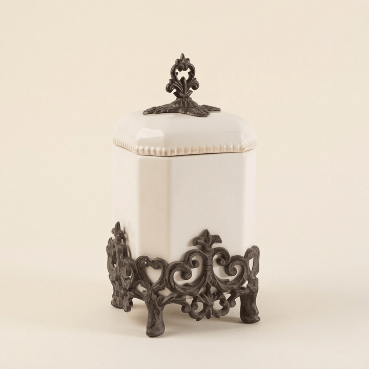 Bellavita cream stoneware canister, 14-inch option, with ornate dark metal base and finial on ivory.