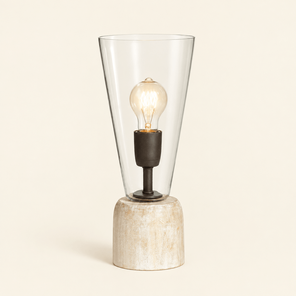 Whitewashed wood mini lamp with tapered clear glass shade and exposed decorative bulb on an ivory background