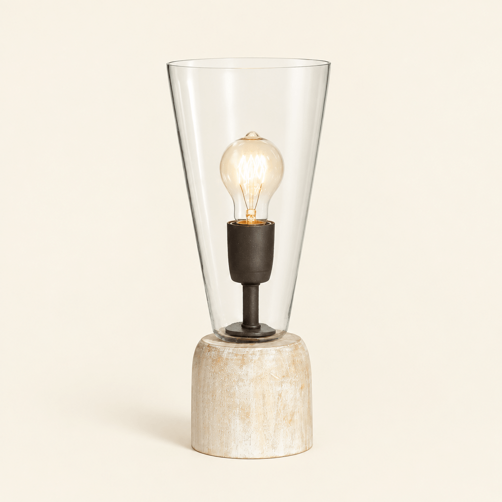 Whitewashed wood mini lamp with tapered clear glass shade and exposed decorative bulb on an ivory background