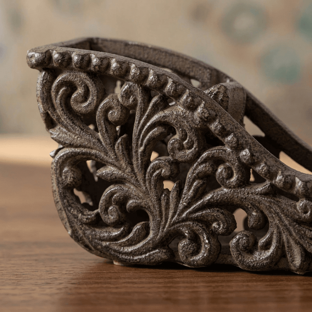 Close-up of the Bellavita Tape Dispenser's openwork acanthus scrollwork in dark antique bronze cast metal