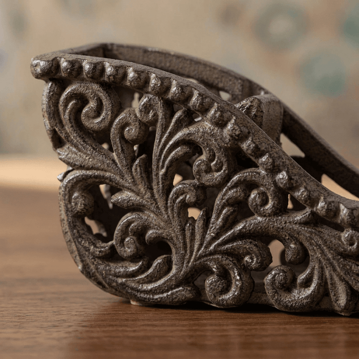 Close-up of the Bellavita Tape Dispenser's openwork acanthus scrollwork in dark antique bronze cast metal