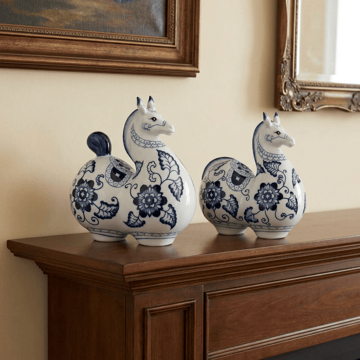 Large and small Blue Blossom Porcelain Horse Statues styled together on a traditional wooden fireplace mantel.