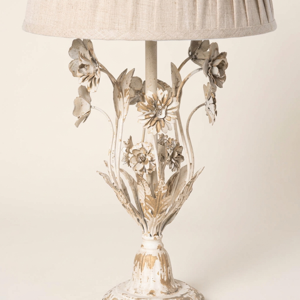 Close-up of the Antique White Floral Table Lamp’s sculpted iron flowers, leaves, and distressed painted finish.