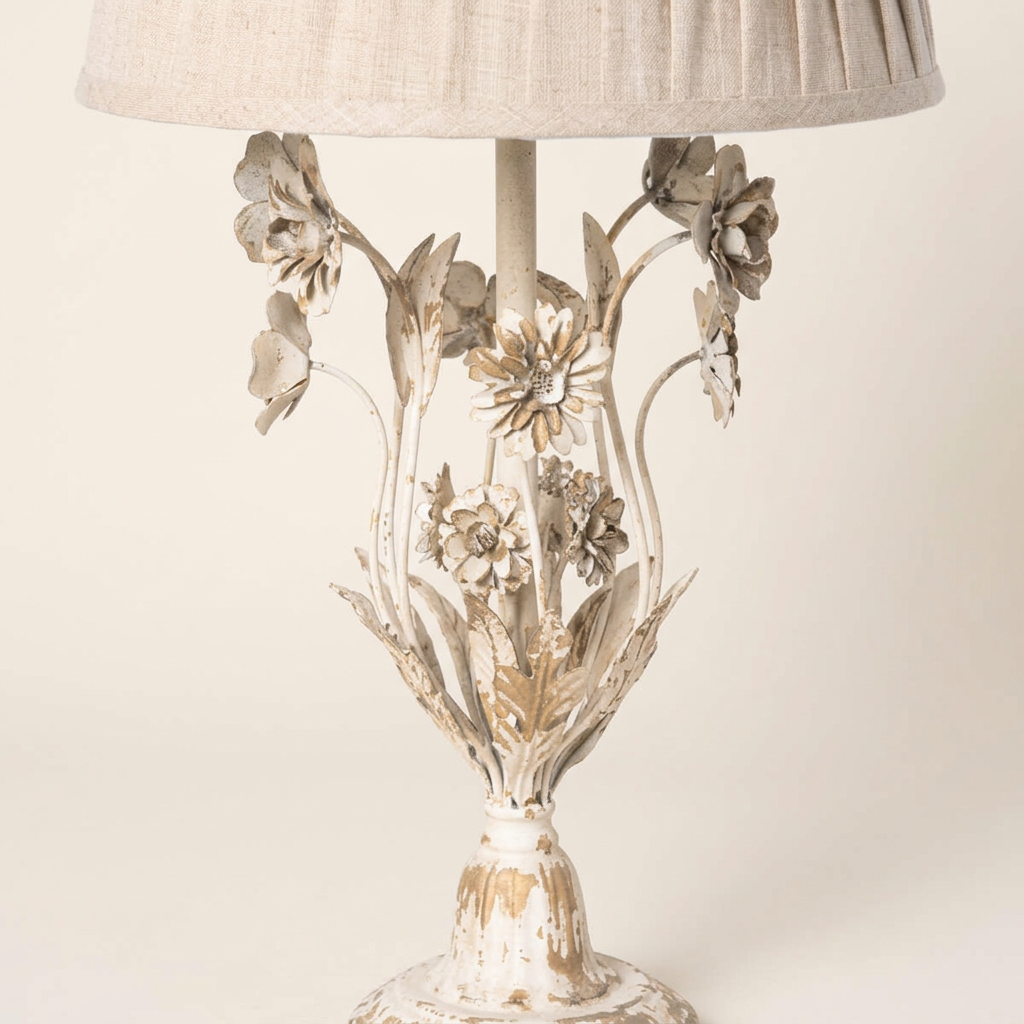 Close-up of the Antique White Floral Table Lamp’s sculpted iron flowers, leaves, and distressed painted finish.