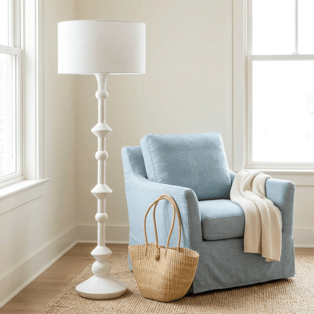 Elara white floor lamp in a coastal reading nook, square lifestyle image