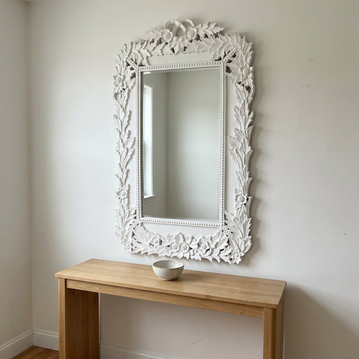 White Chantilly laurel wall mirror above a simple oak entryway console