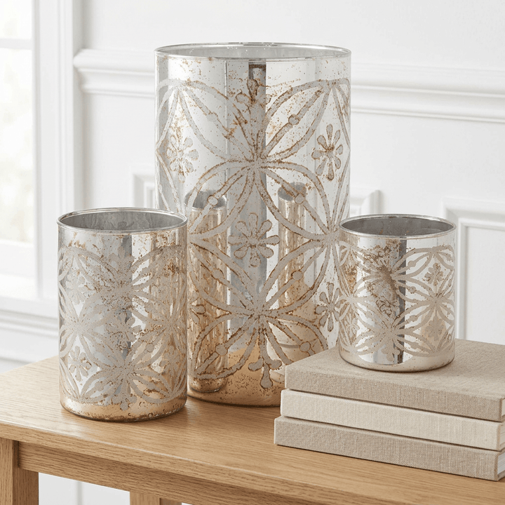 Etched Floral Mercury Glass Candle Holders (Set of 3) on an oak console table beside linen-bound books