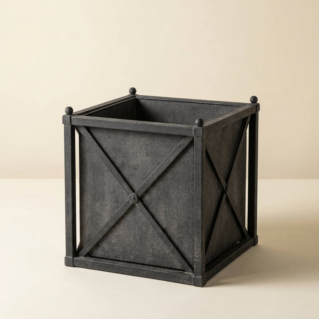 Orangerie Black Iron Estate Planter in Small against an ivory studio background, showing its weathered finish and square basin.