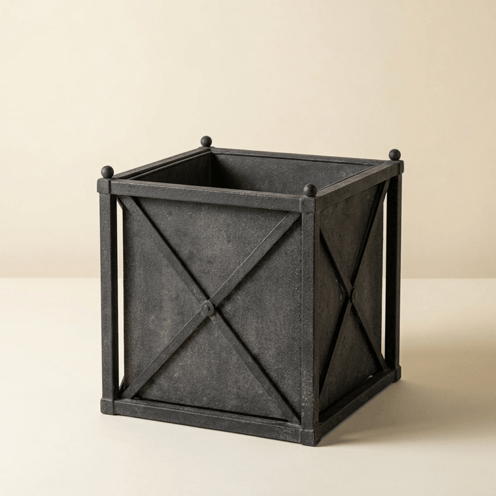 Orangerie Black Iron Estate Planter in Small against an ivory studio background, showing its weathered finish and square basin.