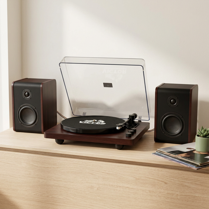 Victor Lincoln record player and two wired stereo speakers arranged on an oak sideboard in a contemporary listening nook.